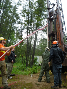 USGS scientists drilling a new well