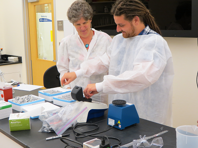Helmholz Center scientist Andreas Kölsch demonstrates arsenic biosensor reading to USGS scientist Dr. Mindy Erickson
