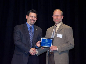 Tim Cowdery (in photo on right) receives the Minnesota WSC’s employee of the year award