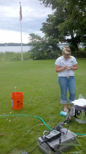 Aliesha Diekoff, USGS hydrologic technician, collected a water sample from a residential well along the shore of White Bear Lake.