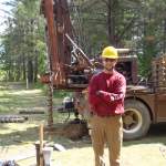 Will poses next to the drill rig